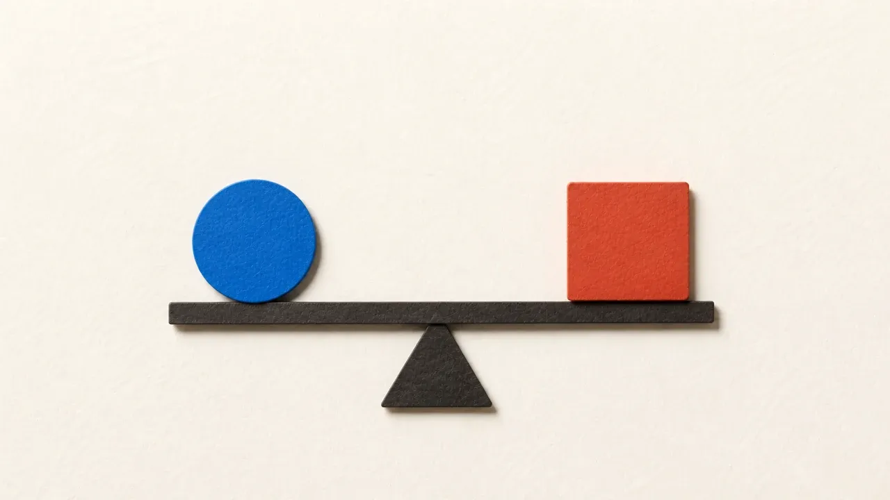 A blue paper circle and orange paper square balanced on a seesaw