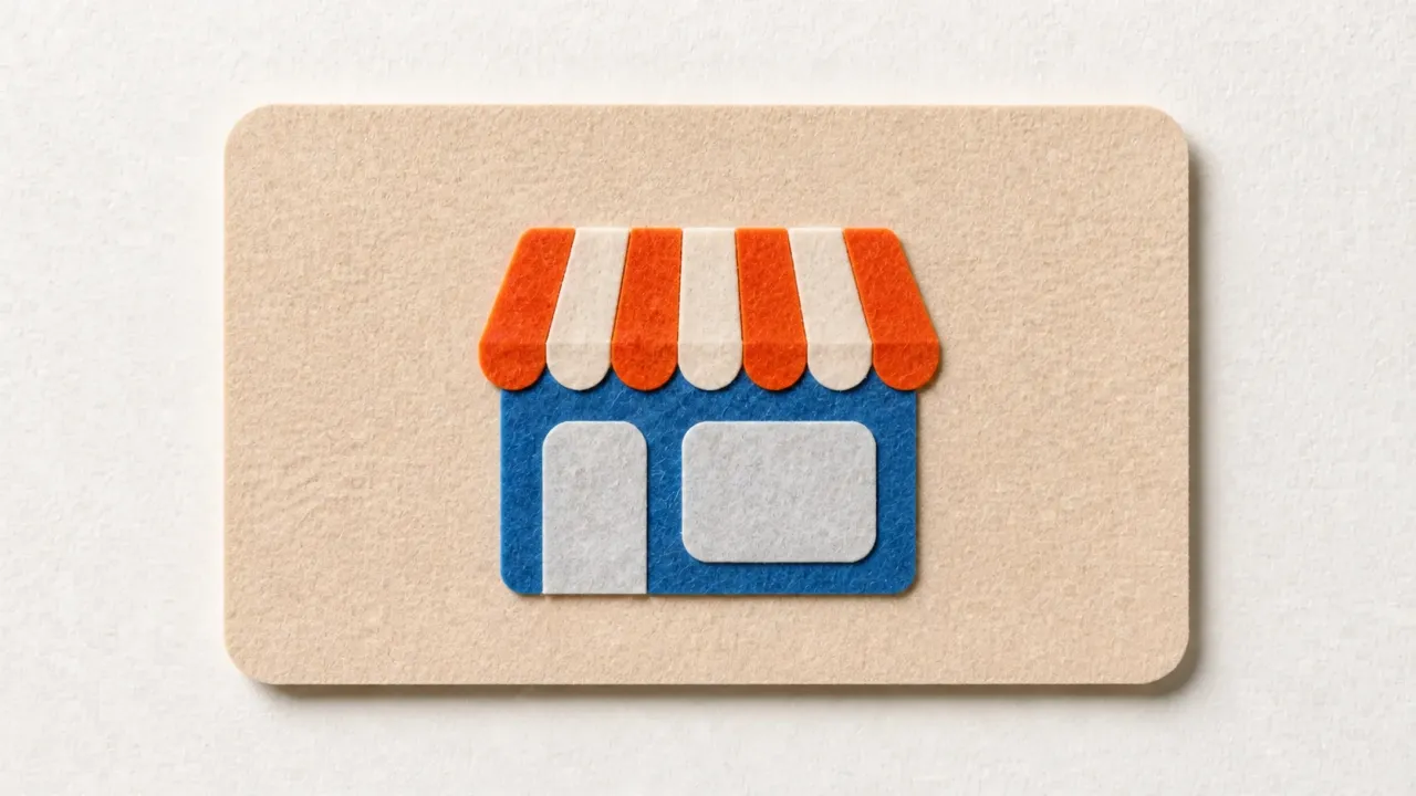 A paper cut-out shopfront with an orange and cream striped awning, a blue front and a grey door and window, on a tan paper card