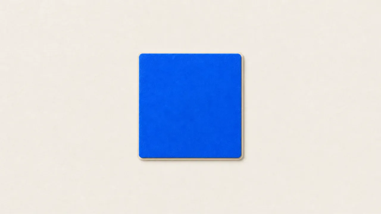 A blue paper square with rounded corners on a pale paper background
