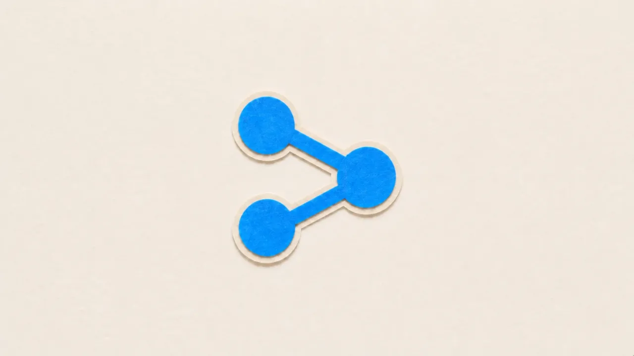 Three blue paper circles joined by short bars into a small graph on a pale paper background