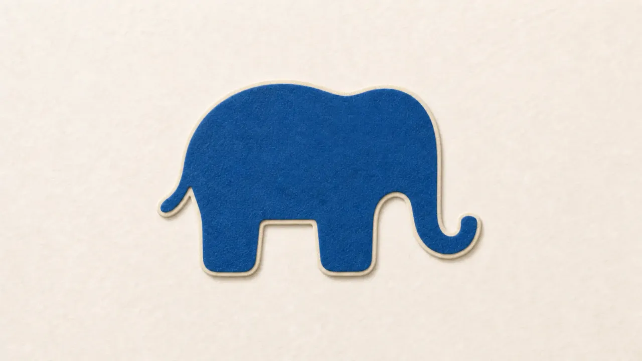 A blue paper elephant head outlined in cream on a pale paper background